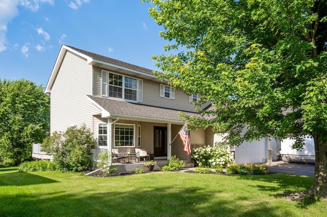12864 Fondant Trl N, Hugo, MN 55038 - view of front of house featuring covered porch, asphalt driveway, a front lawn, a shingled roof, and a garage