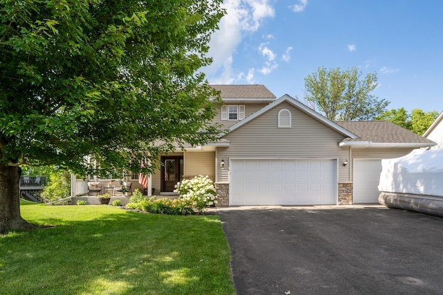 12864 Fondant Trl N, Hugo, MN 55038 - view of front facade featuring driveway, a garage, a front yard, and stone siding