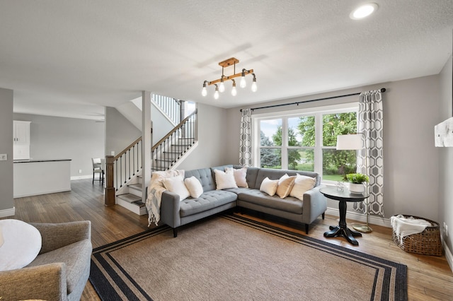 12864 Fondant Trl N, Hugo, MN 55038 - living area featuring stairs, wood finished floors, and a textured ceiling