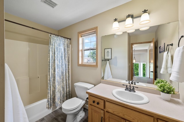 12864 Fondant Trl N, Hugo, MN 55038 - full bath with vanity, shower / bath combination with curtain, and wood finished floors