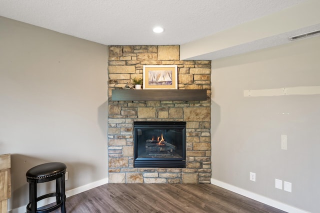 12864 Fondant Trl N, Hugo, MN 55038 - detailed view of a textured ceiling, wood finished floors, and a fireplace