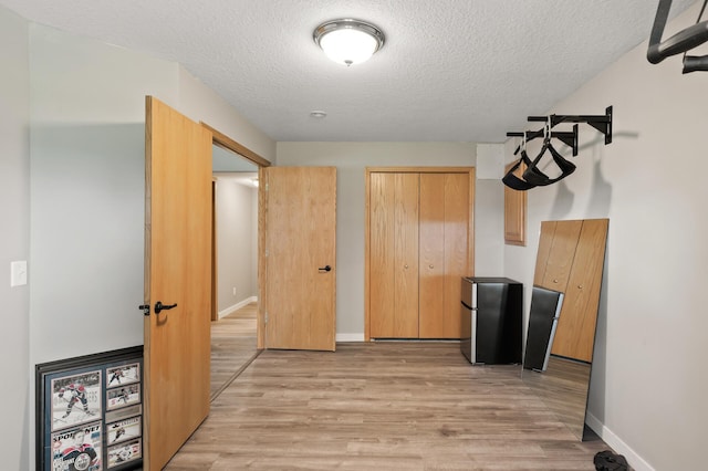 12864 Fondant Trl N, Hugo, MN 55038 - kitchen with a textured ceiling, freestanding refrigerator, light wood finished floors, and light brown cabinets