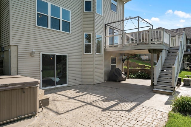 12864 Fondant Trl N, Hugo, MN 55038 - back of property with a hot tub, a patio, stairs, and a deck