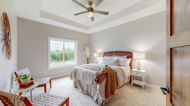509 Golfview Ave, Zumbrota, MN 55992 - bedroom with light carpet, a tray ceiling, and a ceiling fan
