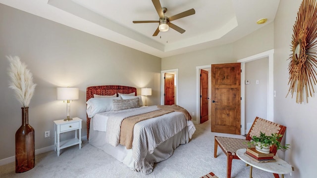 509 Golfview Ave, Zumbrota, MN 55992 - bedroom featuring light colored carpet, a raised ceiling, and ceiling fan
