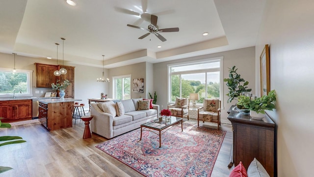 509 Golfview Ave, Zumbrota, MN 55992 - living room featuring a tray ceiling, light wood-type flooring, ceiling fan, and recessed lighting