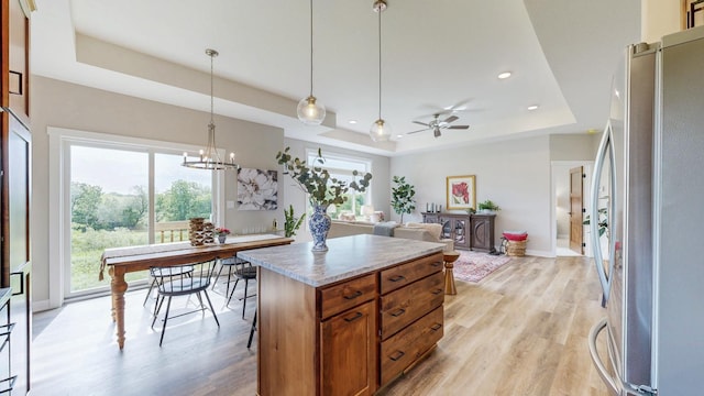 509 Golfview Ave, Zumbrota, MN 55992 - kitchen with freestanding refrigerator, a raised ceiling, healthy amount of natural light, light wood-type flooring, and recessed lighting