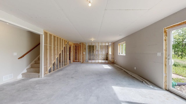 509 Golfview Ave, Zumbrota, MN 55992 - unfurnished living room featuring concrete floors and stairs