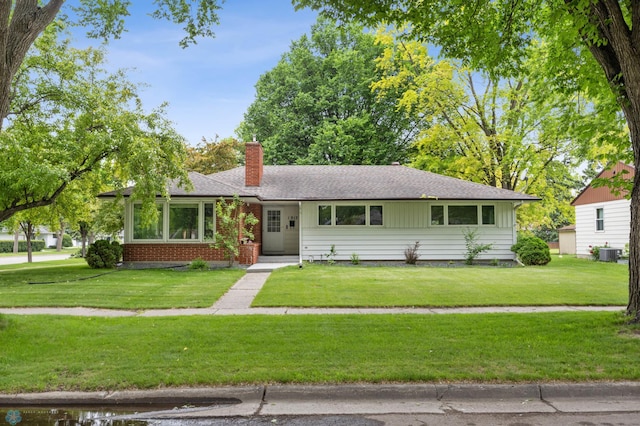 1917 7th St S, Moorhead, MN 56560 - view of front of property featuring a chimney, a front lawn, and roof with shingles