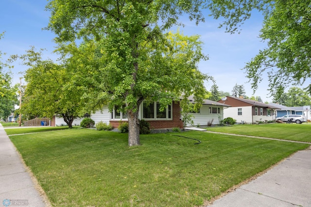 1917 7th St S, Moorhead, MN 56560 - view of front of house with a front lawn and brick siding
