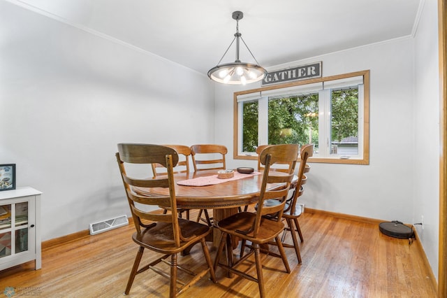 1917 7th St S, Moorhead, MN 56560 - dining space with light wood-type flooring and crown molding