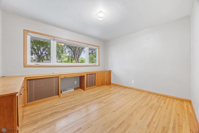 1917 7th St S, Moorhead, MN 56560 - spare room featuring light wood-style floors and built in desk