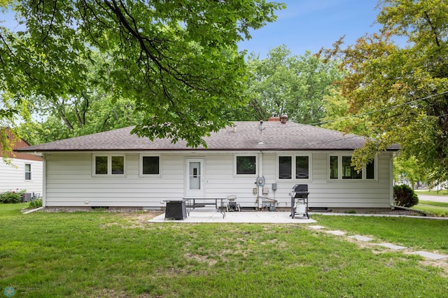 1917 7th St S, Moorhead, MN 56560 - back of property featuring a patio, a yard, and roof with shingles