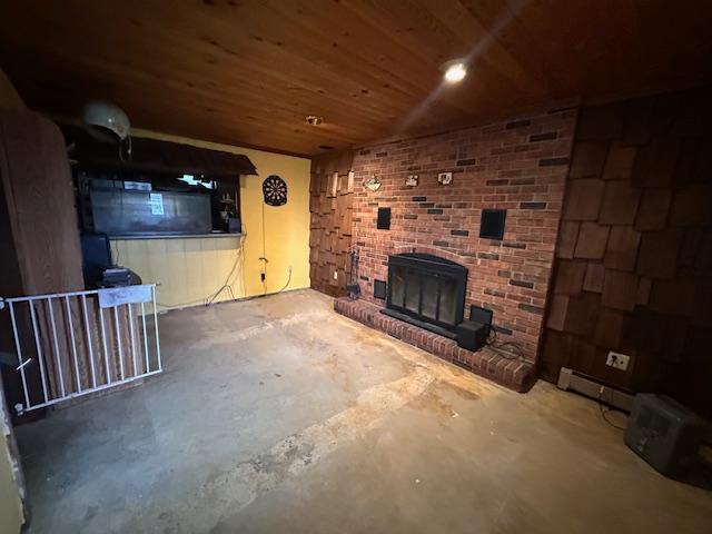 38 Locust Dr, Babbitt, MN 55706 - unfurnished living room featuring concrete flooring, a brick fireplace, wood ceiling, and a baseboard radiator