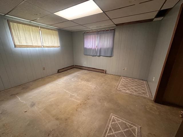 38 Locust Dr, Babbitt, MN 55706 - unfurnished room with unfinished concrete flooring, baseboard heating, and a drop ceiling