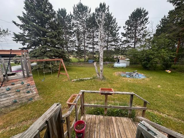 38 Locust Dr, Babbitt, MN 55706 - view of green lawn featuring a playground and a deck