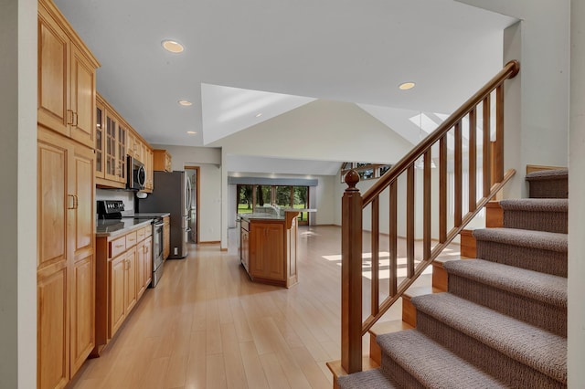 332 Waite Ave S, Saint Cloud, MN 56301 - kitchen with stainless steel appliances, glass insert cabinets, light wood-style flooring, recessed lighting, and a skylight