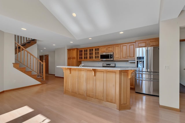 332 Waite Ave S, Saint Cloud, MN 56301 - kitchen featuring appliances with stainless steel finishes, a breakfast bar, recessed lighting, light wood-style flooring, and lofted ceiling