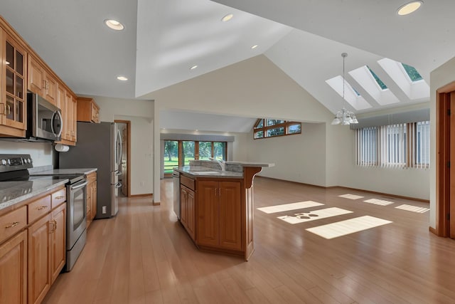 332 Waite Ave S, Saint Cloud, MN 56301 - kitchen with stainless steel appliances, a skylight, glass insert cabinets, light stone counters, and open floor plan