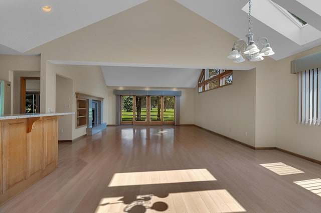 332 Waite Ave S, Saint Cloud, MN 56301 - unfurnished living room featuring high vaulted ceiling, a chandelier, and light wood-style floors