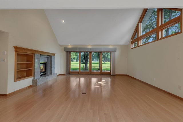 332 Waite Ave S, Saint Cloud, MN 56301 - unfurnished living room featuring high vaulted ceiling, light wood finished floors, and a fireplace