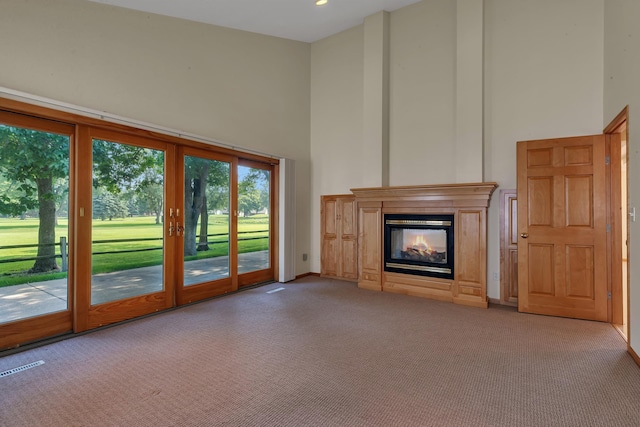 332 Waite Ave S, Saint Cloud, MN 56301 - unfurnished living room with a high ceiling, carpet flooring, and a multi sided fireplace