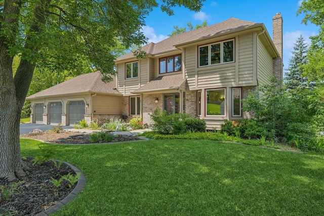 6233 Fernbrook Ln N, Maple Grove, MN 55311 - view of front of home with a chimney, a garage, a front yard, roof with shingles, and asphalt driveway