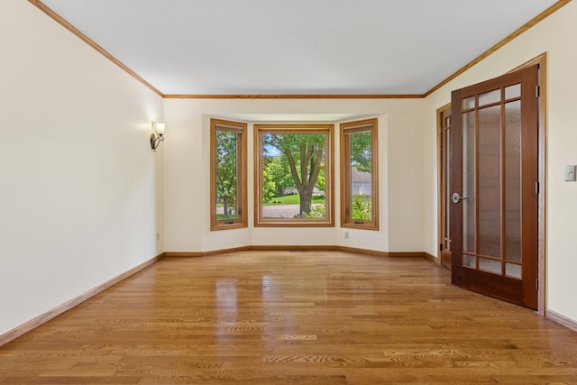 6233 Fernbrook Ln N, Maple Grove, MN 55311 - empty room with crown molding and light wood-style flooring