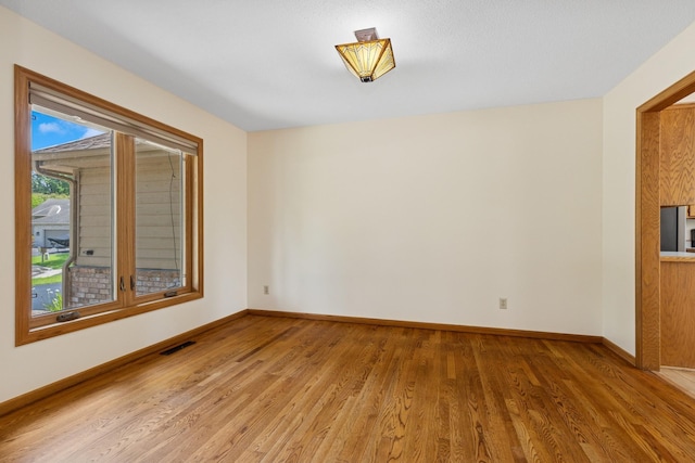 6233 Fernbrook Ln N, Maple Grove, MN 55311 - unfurnished room featuring light wood-type flooring and baseboards