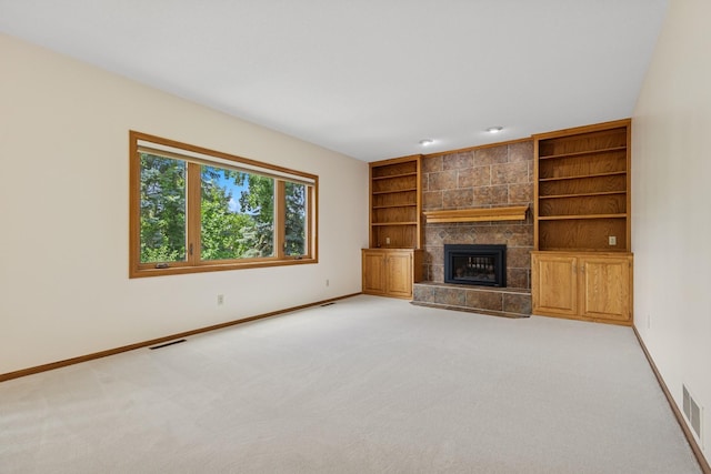6233 Fernbrook Ln N, Maple Grove, MN 55311 - unfurnished living room featuring built in shelves, light colored carpet, and a tile fireplace