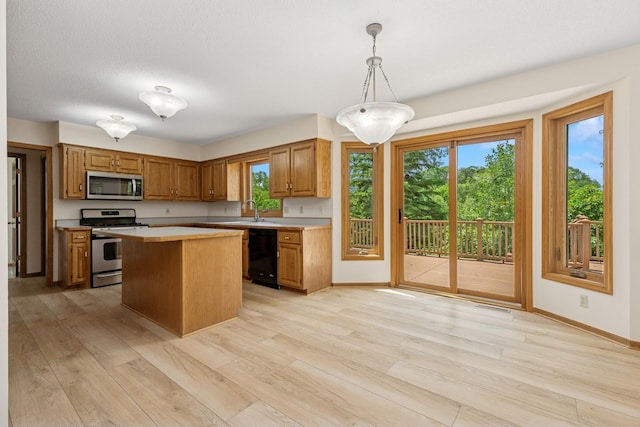 6233 Fernbrook Ln N, Maple Grove, MN 55311 - kitchen with stainless steel appliances, light countertops, light wood finished floors, a center island, and brown cabinetry