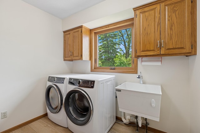 6233 Fernbrook Ln N, Maple Grove, MN 55311 - laundry area with washing machine and dryer, cabinet space, and light wood-type flooring