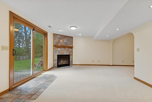 6233 Fernbrook Ln N, Maple Grove, MN 55311 - unfurnished living room featuring a tile fireplace, recessed lighting, carpet, and arched walkways