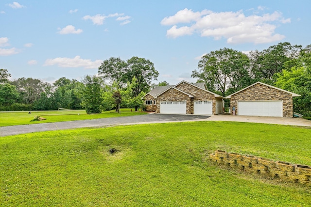 3220 Vine St, Cambridge, MN 55008 - view of front of house with asphalt driveway, stone siding, a front yard, an attached garage, and view of wooded area