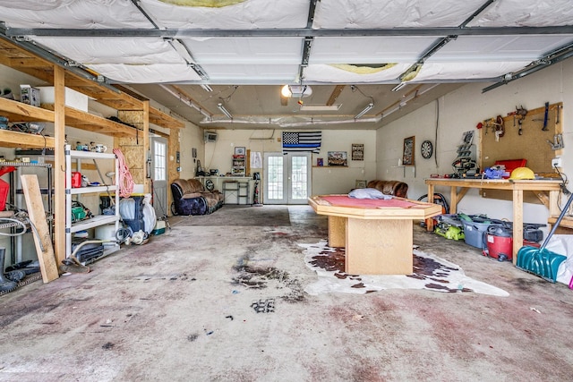 3220 Vine St, Cambridge, MN 55008 - garage with french doors, a workshop area, and a garage door opener