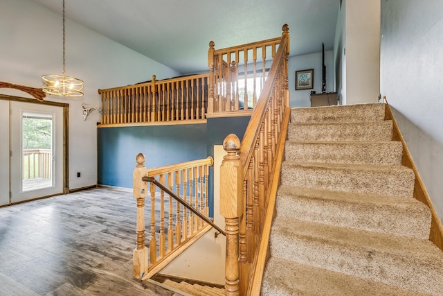 3220 Vine St, Cambridge, MN 55008 - stairs featuring wood finished floors, a chandelier, and high vaulted ceiling