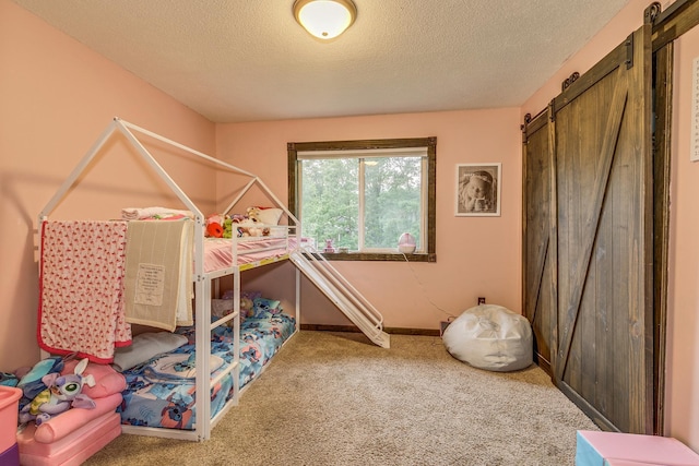 3220 Vine St, Cambridge, MN 55008 - bedroom featuring a barn door, carpet, and a textured ceiling
