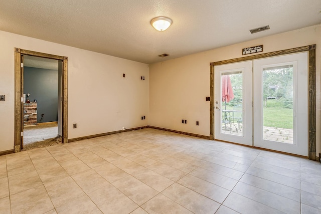 3220 Vine St, Cambridge, MN 55008 - empty room with a textured ceiling and light tile patterned floors