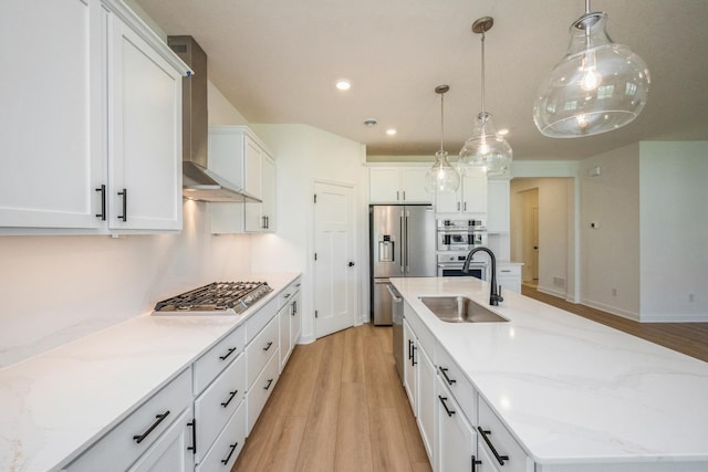 14526 111th Ave E, Dayton, MN 55369 - kitchen with a sink, appliances with stainless steel finishes, wall chimney exhaust hood, a large island with sink, and light wood-style floors