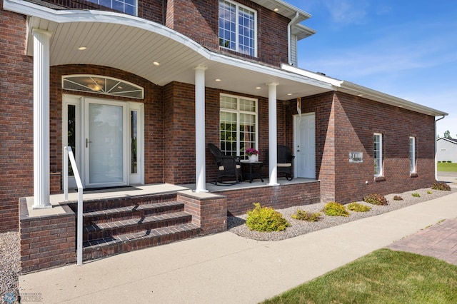 215 51st Ave E, West Fargo, ND 58078 - property entrance featuring covered porch and brick siding