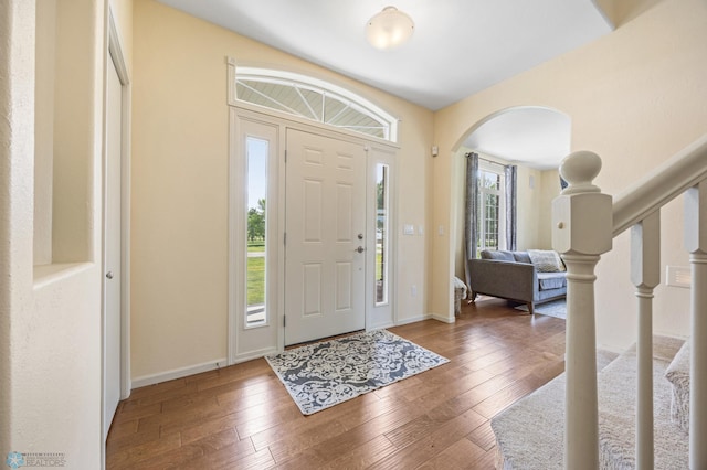 215 51st Ave E, West Fargo, ND 58078 - entryway featuring wood-type flooring, arched walkways, and stairs