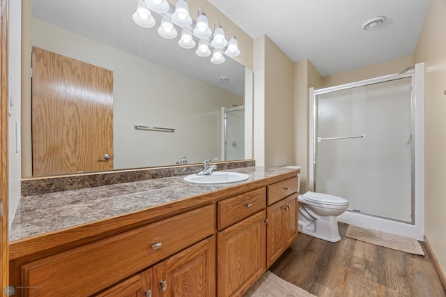 215 51st Ave E, West Fargo, ND 58078 - bathroom featuring wood finished floors, a shower stall, and vanity