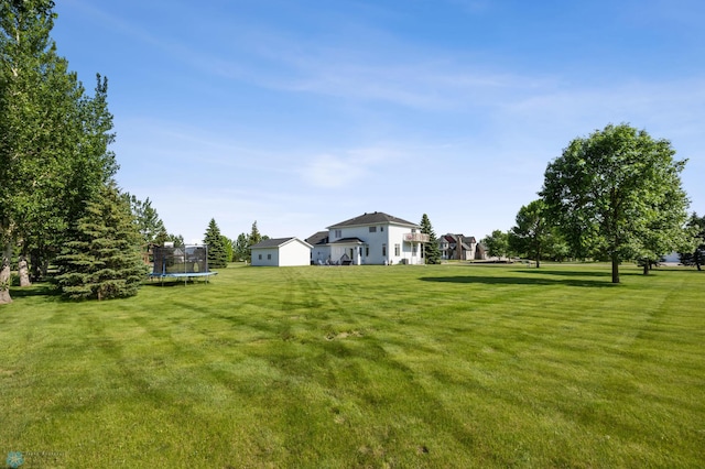 215 51st Ave E, West Fargo, ND 58078 - view of grassy yard featuring a trampoline