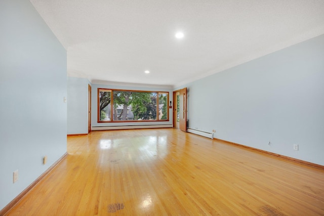895 Humboldt Ave W, Saint Paul, MN 55118 - spare room featuring a baseboard heating unit, light wood-type flooring, and recessed lighting