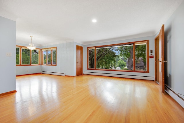895 Humboldt Ave W, Saint Paul, MN 55118 - unfurnished room featuring a baseboard radiator, a chandelier, light wood-style floors, and recessed lighting