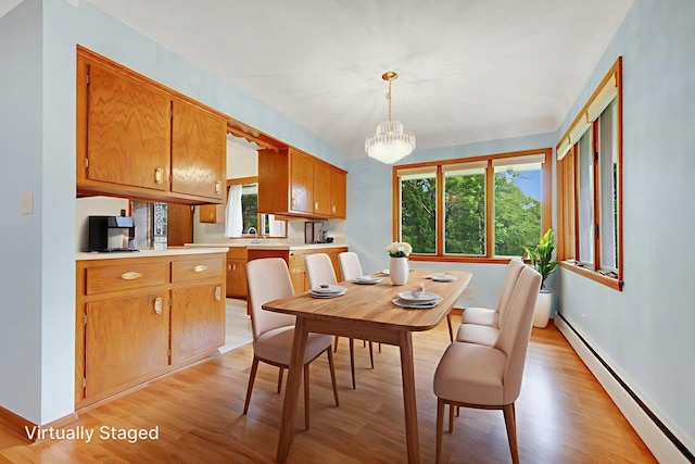 895 Humboldt Ave W, Saint Paul, MN 55118 - dining room featuring a baseboard heating unit, light wood-type flooring, and a chandelier