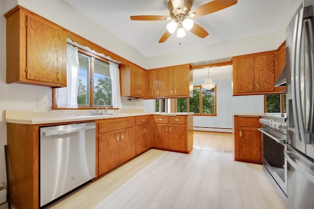 895 Humboldt Ave W, Saint Paul, MN 55118 - kitchen with stainless steel appliances, baseboard heating, brown cabinets, and healthy amount of natural light