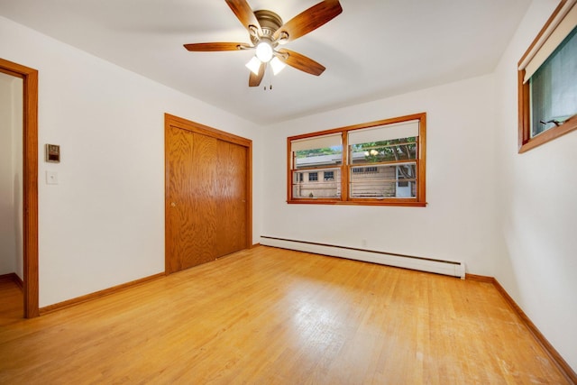 895 Humboldt Ave W, Saint Paul, MN 55118 - unfurnished bedroom with baseboard heating, light wood-style flooring, a closet, and a ceiling fan