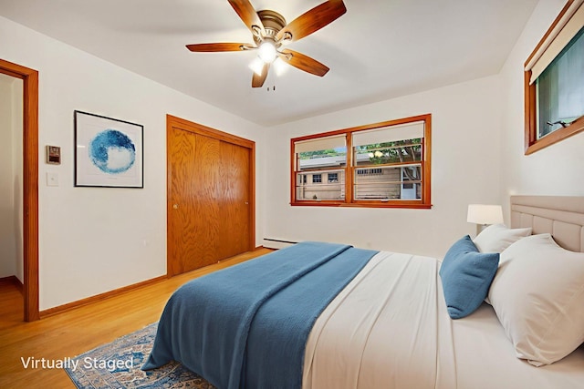 895 Humboldt Ave W, Saint Paul, MN 55118 - bedroom with light wood finished floors, a baseboard radiator, a closet, and ceiling fan