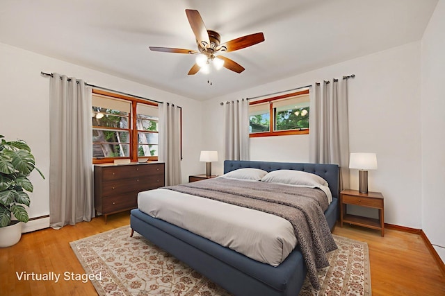 895 Humboldt Ave W, Saint Paul, MN 55118 - bedroom featuring multiple windows, light wood-style flooring, and a ceiling fan